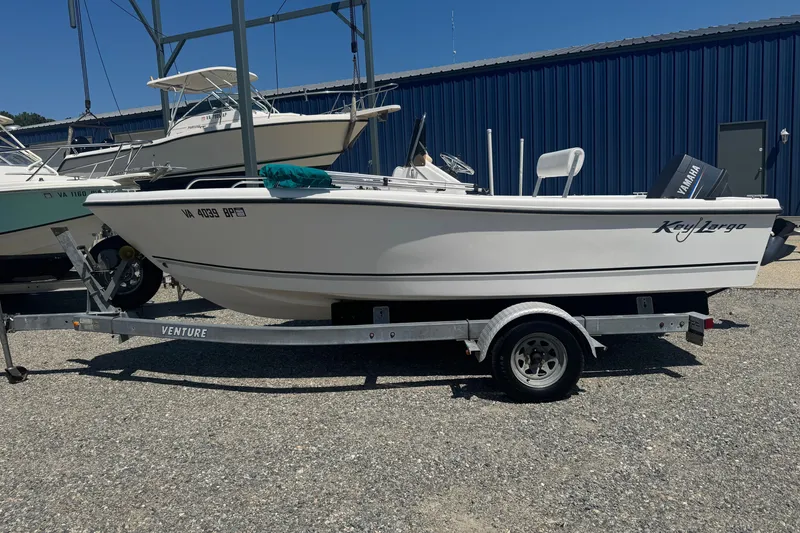 The Image of 2009 Key Largo 1800 Center Console boat on trailer, parked outdoors. - 1