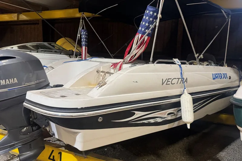 Slide: The Image of 2005 Vectra S-200 boat with Yamaha outboard motor in storage. - 15