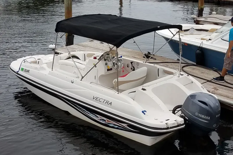 Slide: The Image of 2005 Vectra S-200 boat docked with Yamaha outboard motor, black canopy. - 4