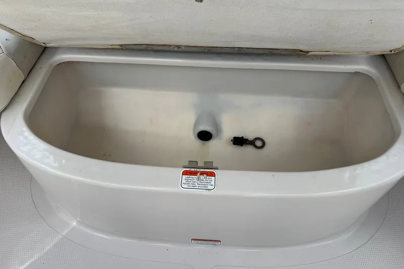 Slide: The Image of 2009 Tahoe Q4 SS boat storage compartment with drain plug inside. - 21