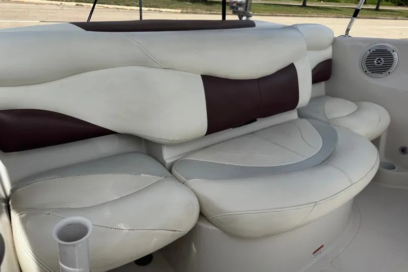 Slide: The Image of 2009 Tahoe Q4 SS boat interior with white and maroon cushioned seating. - 7