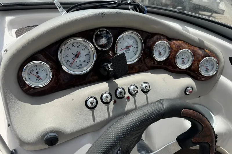 Slide: The Image of Dashboard of a 2009 Tahoe Q4 SS boat with gauges and controls. - 16