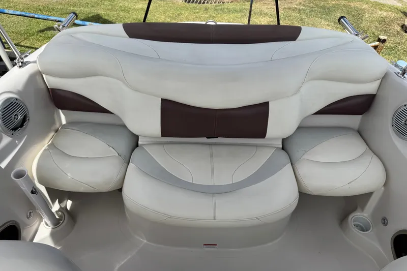 Slide: The Image of 2009 Tahoe Q4 SS boat interior with white and brown cushioned seating. - 11