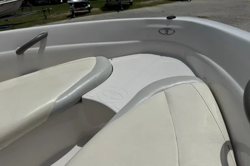 Slide: The Image of Interior of a 2009 Tahoe Q4 SS boat with white cushioned seating. - 5