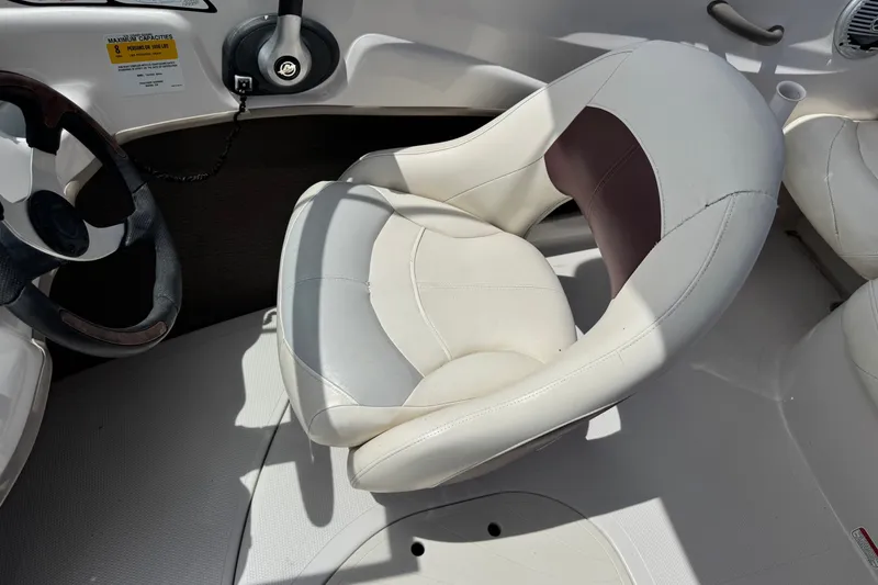 Slide: The Image of 2009 Tahoe Q4 SS boat interior with white captain's chair and steering wheel. - 19