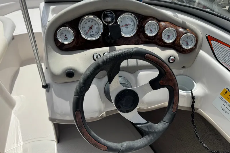 Slide: The Image of 2009 Tahoe Q4 SS boat dashboard with gauges and steering wheel. - 15