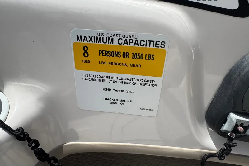 Slide: The Image of 2009 Tahoe Q4 SS boat capacity label, 8 persons or 1050 lbs, U.S. Coast Guard compliant. - 25