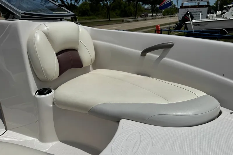 Slide: The Image of 2009 Tahoe Q4 SS boat interior with white cushioned seating and cup holder. - 4