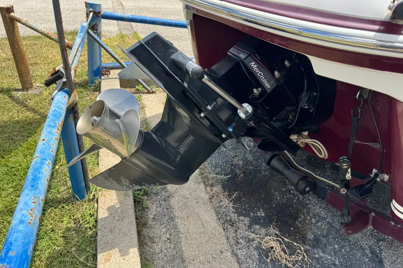 Slide: The Image of 2009 Tahoe Q4 SS boat with MerCruiser outboard motor and propeller, parked on a trailer. - 10