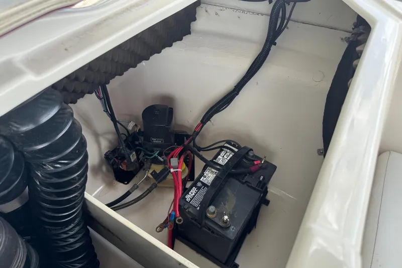 Slide: The Image of 2009 Tahoe Q4 SS boat battery compartment with wiring and components. - 24