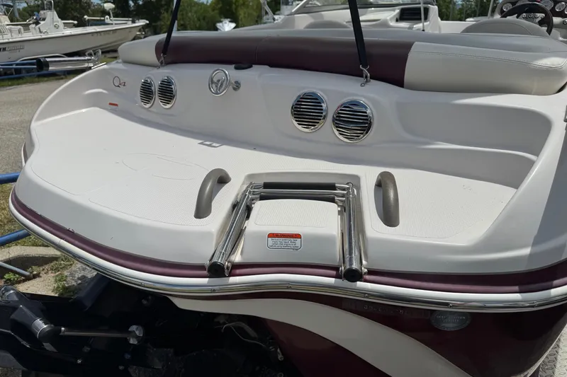 Slide: The Image of 2009 Tahoe Q4 SS boat with swim platform and ladder, featuring sleek design and chrome accents. - 9