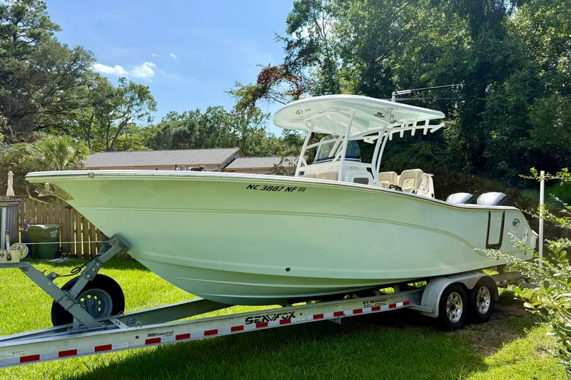 The Image of 2017 Sea Fox 288 Commander boat on trailer, parked in a grassy yard. - 0