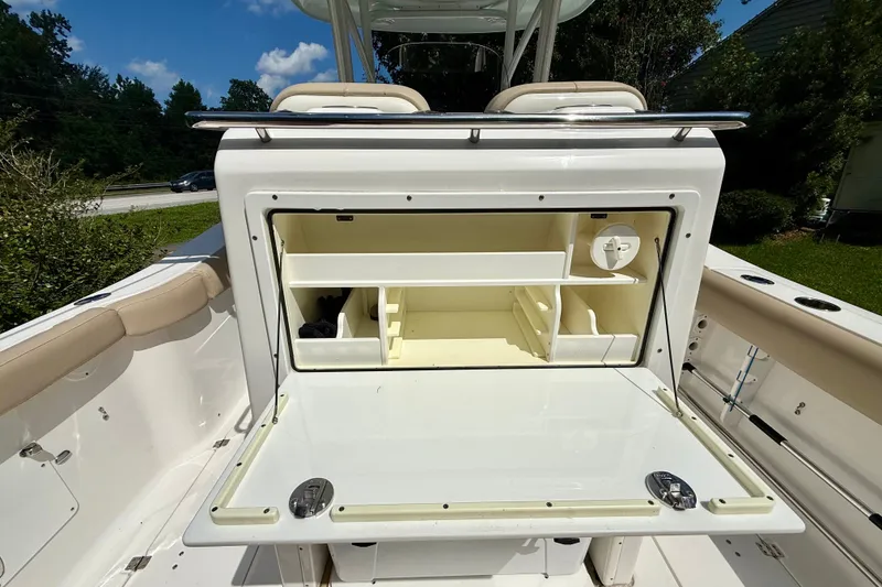 Slide: The Image of 2017 Sea Fox 288 Commander boat with open storage compartment under sunny sky. - 17