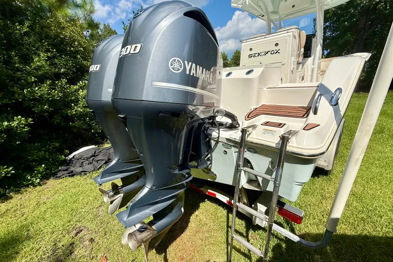 Slide: The Image of 2017 Sea Fox 288 Commander with dual Yamaha 300 engines, parked on grass. - 4