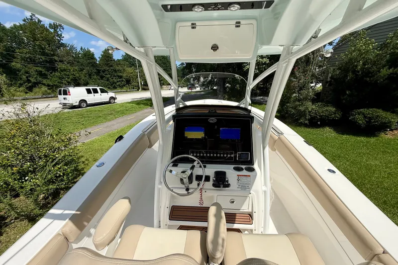 Slide: The Image of 2017 Sea Fox 288 Commander boat cockpit with steering wheel and navigation screens. - 22