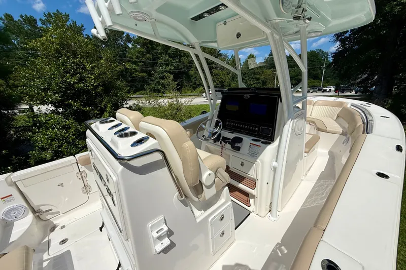 Slide: The Image of 2017 Sea Fox 288 Commander boat interior with helm, seating, and console under sunny skies. - 18