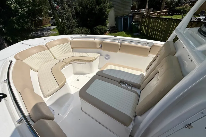 Slide: The Image of 2017 Sea Fox 288 Commander boat interior with beige seating and cup holders. - 26