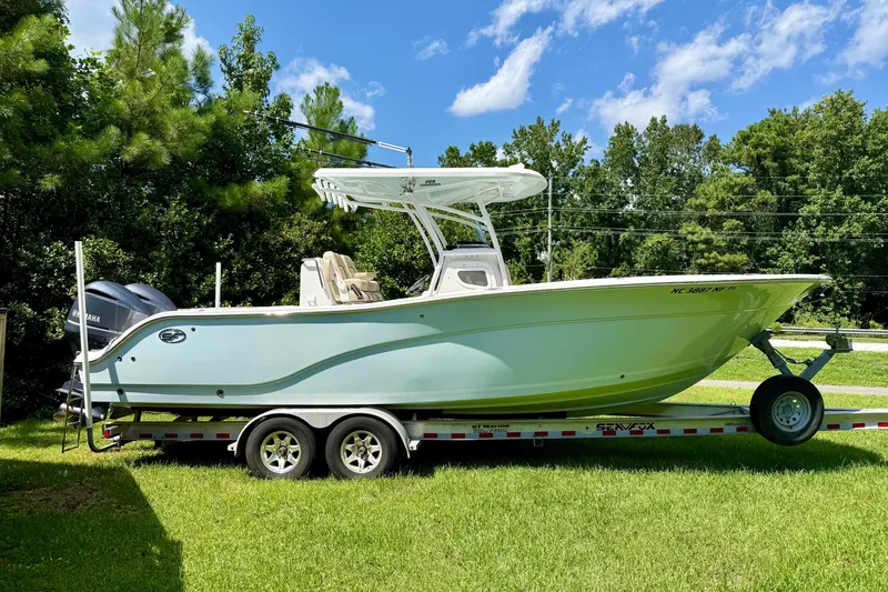 Slide: The Image of 2017 Sea Fox 288 Commander boat on trailer, surrounded by lush greenery. - 5