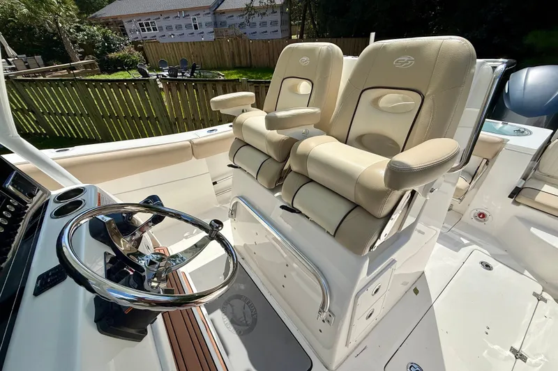 Slide: The Image of 2017 Sea Fox 288 Commander boat interior with dual captain's chairs and steering wheel. - 21