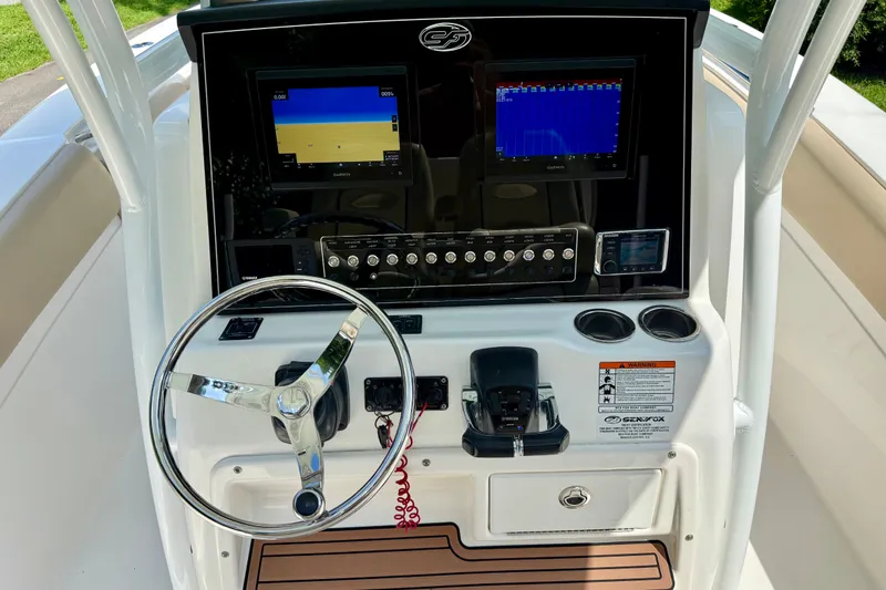 Slide: The Image of 2017 Sea Fox 288 Commander dashboard with steering wheel, controls, and dual displays. - 23