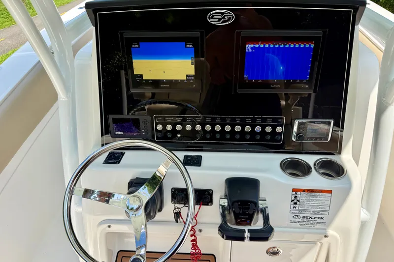 Slide: The Image of 2017 Sea Fox 288 Commander boat dashboard with dual Garmin displays and steering wheel. - 24
