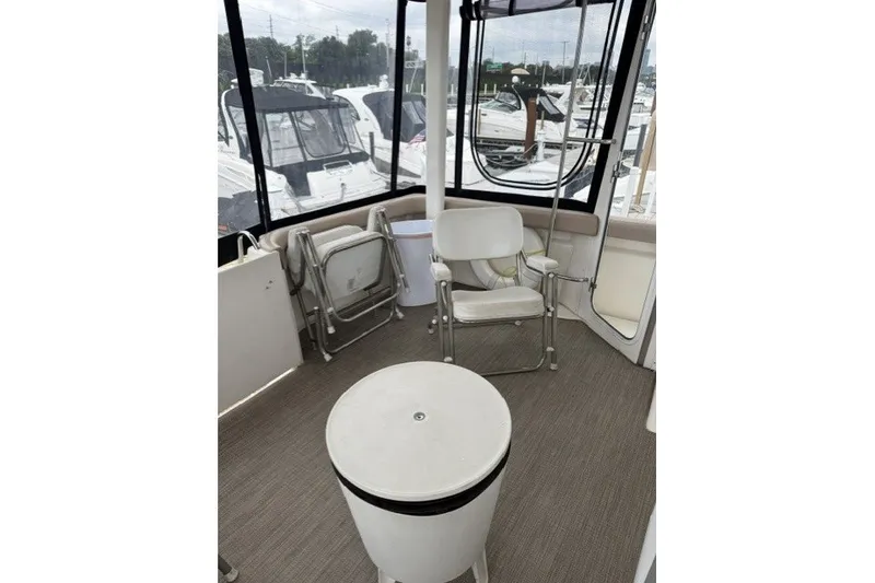Slide: The Image of Interior view of 2000 Silverton 422 Motor Yacht with seating and table. - 15