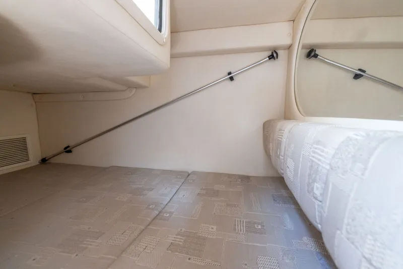 Slide: The Image of Interior cabin of 2002 Sea Ray Sundancer 260, featuring a cozy sleeping area. - 20