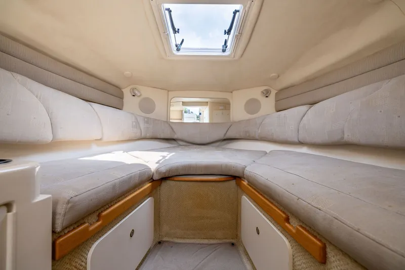 Slide: The Image of Interior cabin of 2002 Sea Ray Sundancer 260 with cushioned seating and overhead hatch. - 21