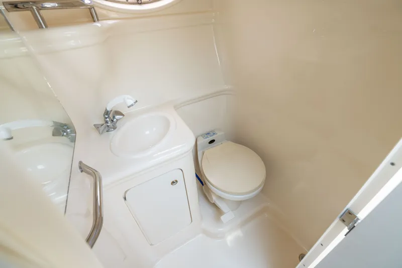 Slide: The Image of Compact bathroom in 2002 Sea Ray Sundancer 260 boat, featuring sink and toilet. - 19