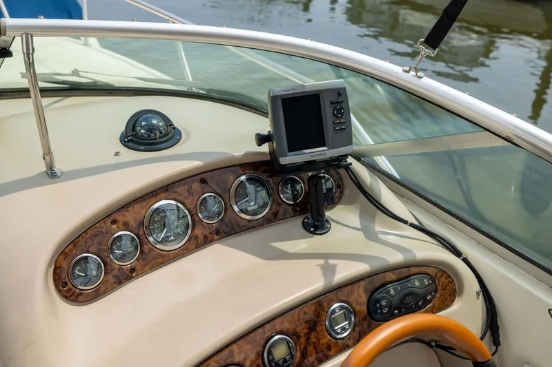 Slide: The Image of Dashboard of a 2002 Sea Ray Sundancer 260 boat with navigation instruments. - 13