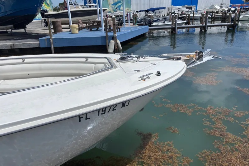 Slide: The Image of 2006 Boston Whaler Outrage 270 docked at marina, front view. - 26