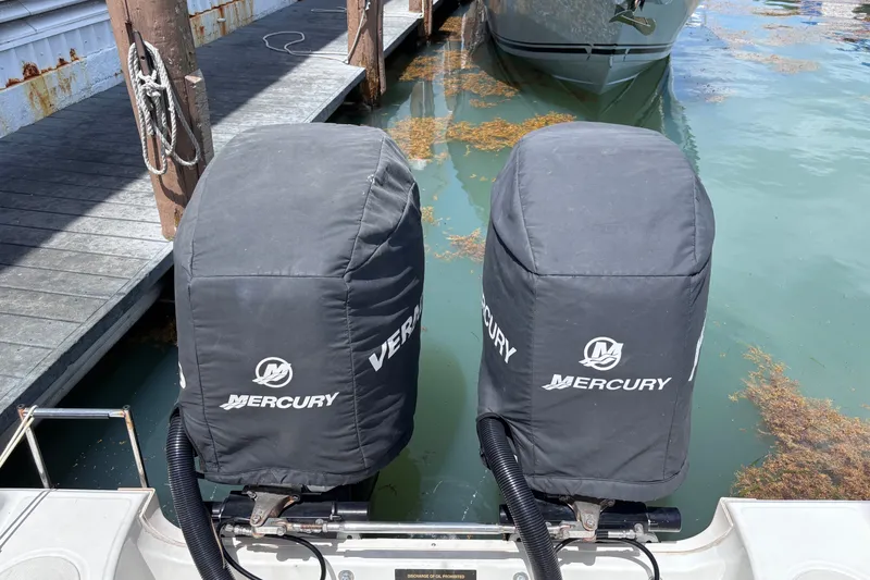 Slide: The Image of Twin Mercury outboard engines on a 2006 Boston Whaler Outrage 270 boat. - 13