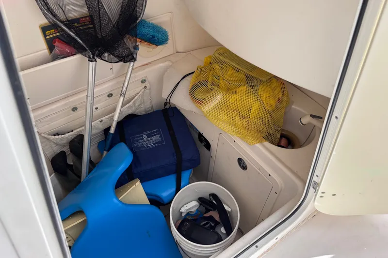 Slide: The Image of Storage compartment of a 2006 Boston Whaler Outrage 270 with boating gear and accessories. - 23