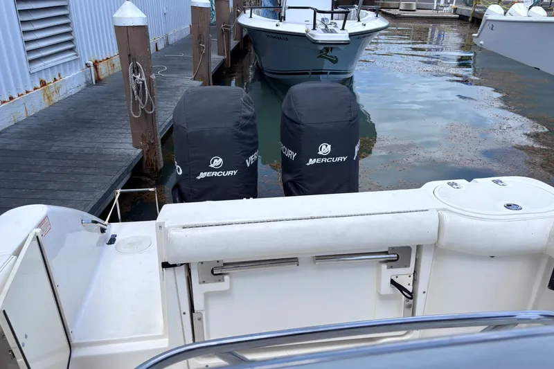 Slide: The Image of 2006 Boston Whaler Outrage 270 with twin Mercury outboard engines at dock. - 16