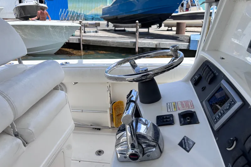 Slide: The Image of 2006 Boston Whaler Outrage 270 helm with steering wheel and control panel. - 22