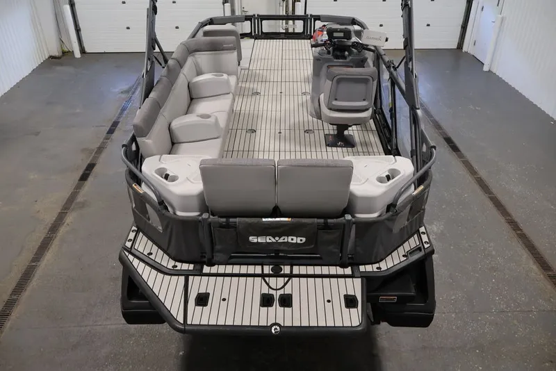 Slide: The Image of 2022 Sea-Doo Switch Sport 21 pontoon boat with spacious seating and modern design. - 21