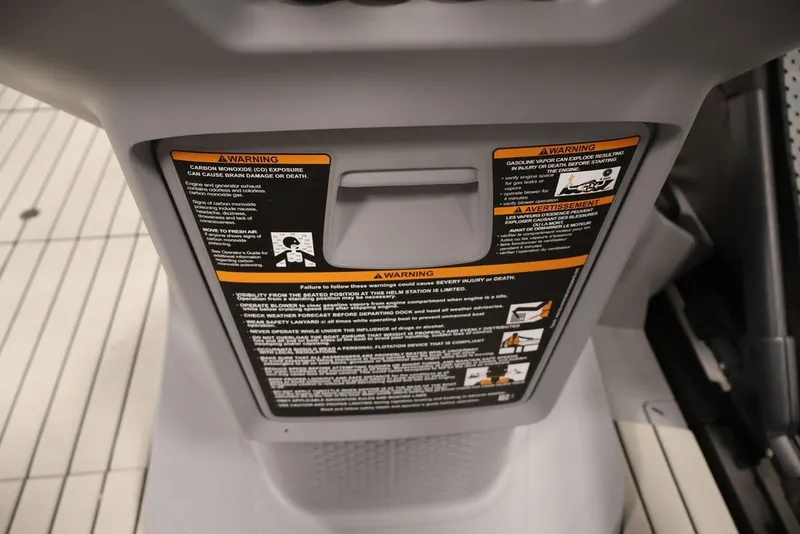 Slide: The Image of 2022 Sea-Doo Switch Sport 21 warning labels on dashboard, emphasizing safety precautions. - 24