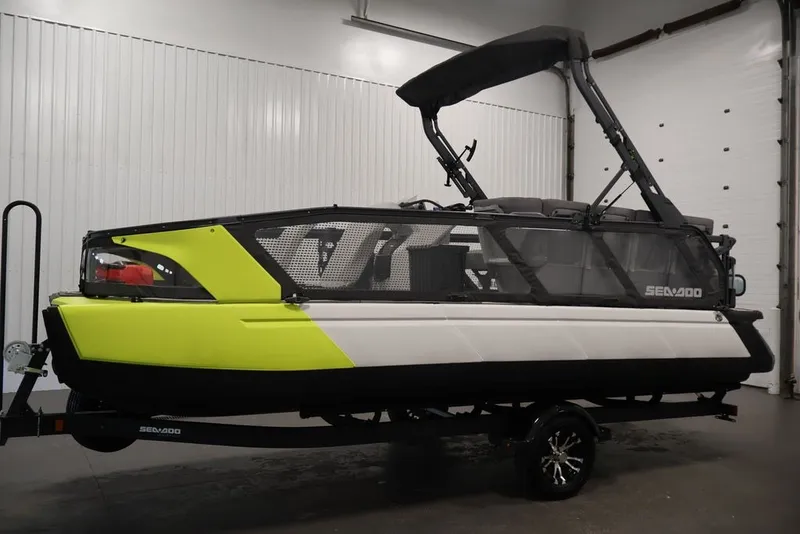 Slide: The Image of 2022 Sea-Doo Switch Sport 21 boat in a showroom, featuring a vibrant yellow and black design. - 19