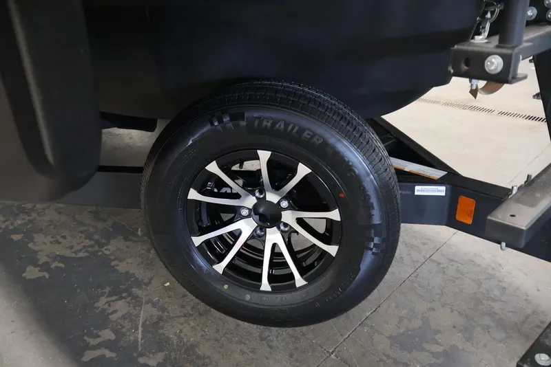 Slide: The Image of Trailer wheel of 2022 Sea-Doo Switch Sport 21, featuring sleek black and silver design. - 35