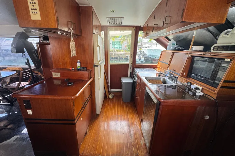 Slide: The Image of 1989 Ocean Yachts 48 Motor Yacht kitchen with wooden cabinetry and modern appliances. - 67