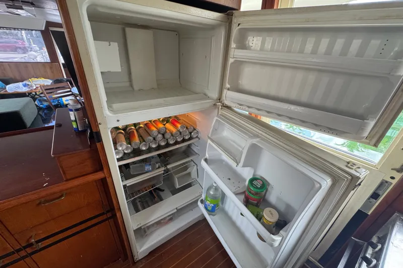 Slide: The Image of Open refrigerator inside 1989 Ocean Yachts 48 Motor Yacht, stocked with drinks and condiments. - 74