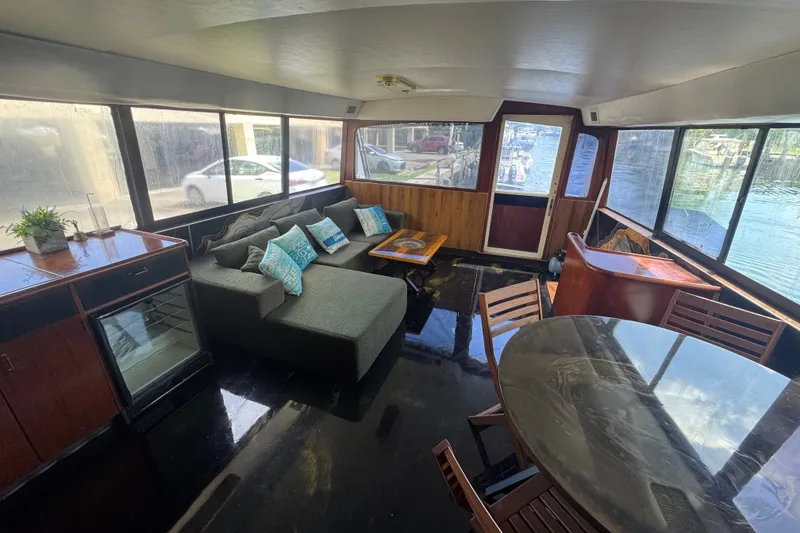 Slide: The Image of 1989 Ocean Yachts 48 Motor Yacht interior with seating, table, and panoramic windows. - 57