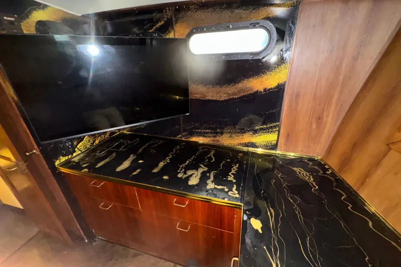 Slide: The Image of Luxurious interior of 1989 Ocean Yachts 48 Motor Yacht with sleek black and gold accents. - 117