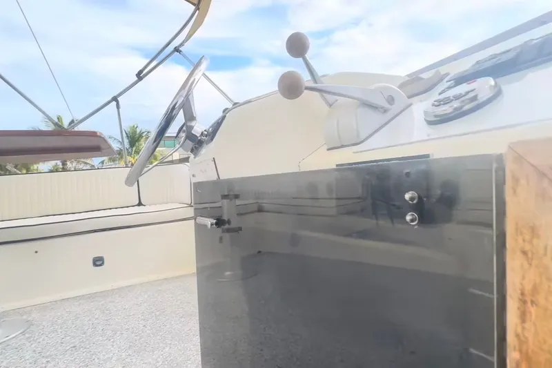 Slide: The Image of 1989 Ocean Yachts 48 Motor Yacht helm with steering wheel and controls. - 35