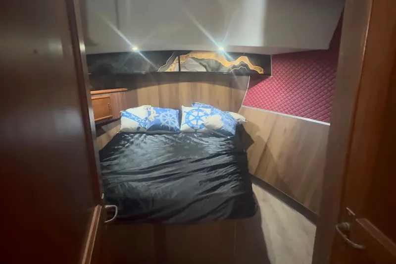 Slide: The Image of Cozy bedroom in 1989 Ocean Yachts 48 Motor Yacht with nautical-themed pillows. - 46