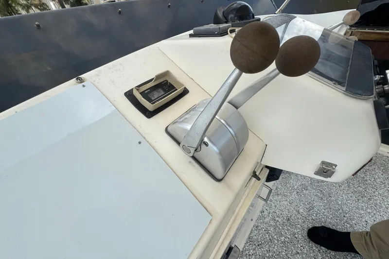 Slide: The Image of Control panel of a 1989 Ocean Yachts 48 Motor Yacht with throttle levers. - 105