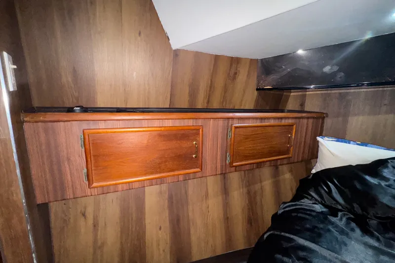 Slide: The Image of Interior of 1989 Ocean Yachts 48 Motor Yacht with wooden cabinets and bedding. - 91