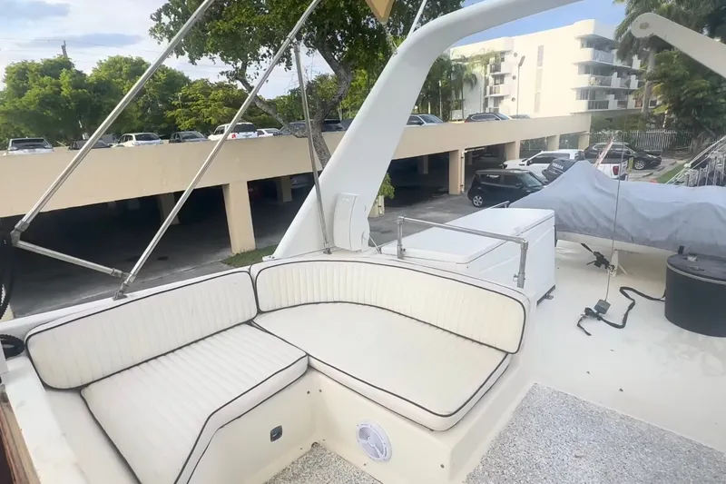Slide: The Image of 1989 Ocean Yachts 48 Motor Yacht deck with white seating and marina view. - 41