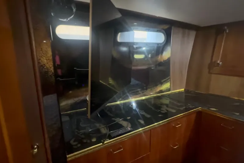 Slide: The Image of Interior of 1989 Ocean Yachts 48 Motor Yacht with sleek countertops and wooden cabinetry. - 30