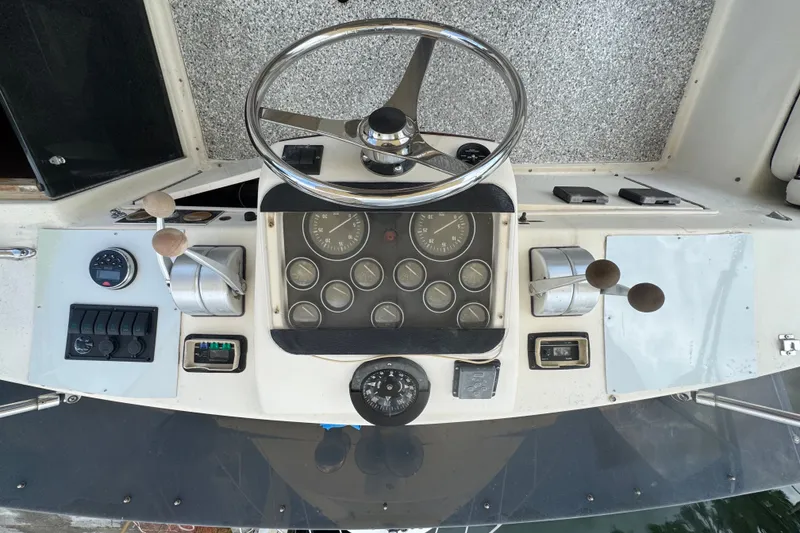 Slide: The Image of 1989 Ocean Yachts 48 Motor Yacht helm with steering wheel and control panel. - 102